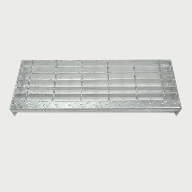 Welded steel stair tread with open grating